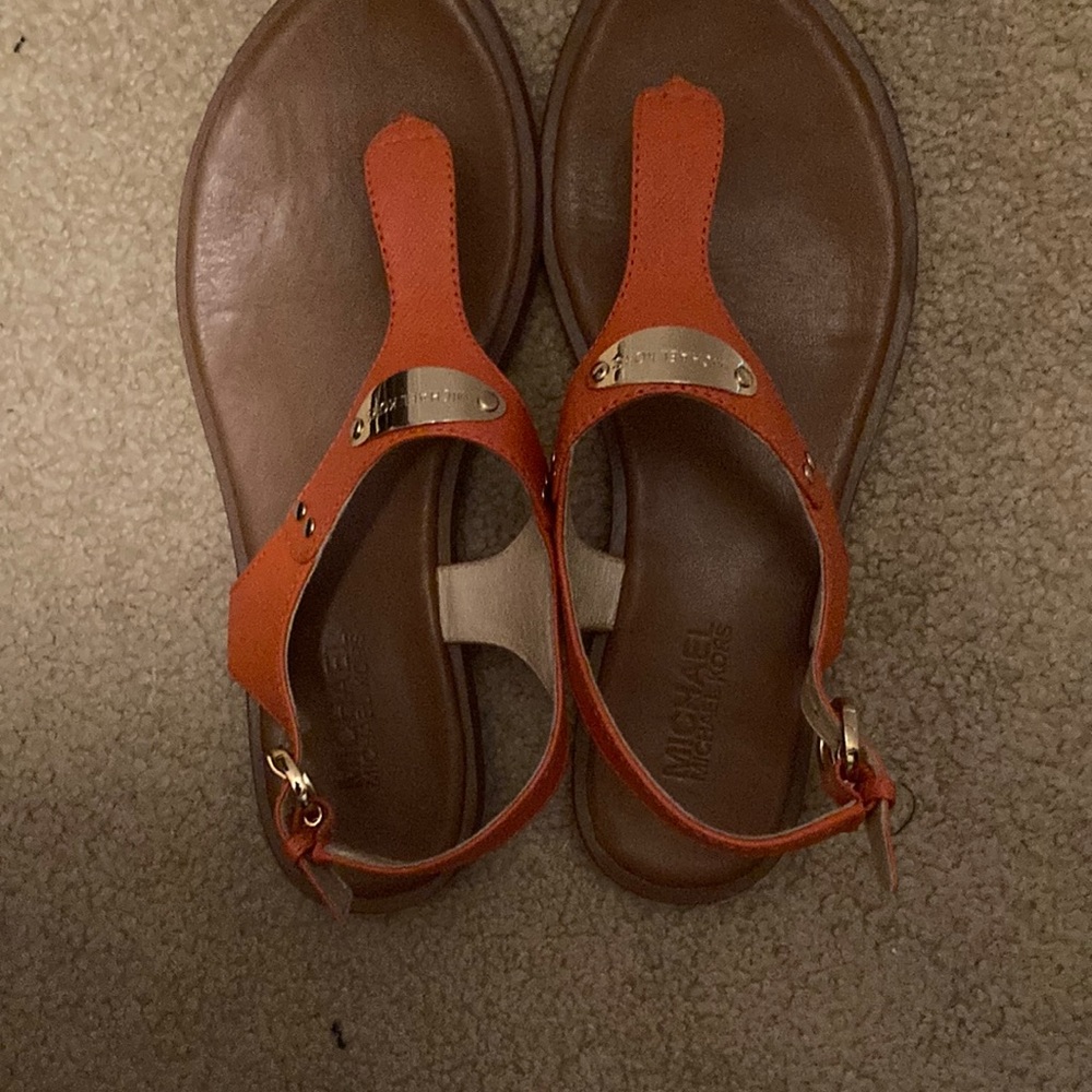 Michael Kors orange sandals with gold plate.